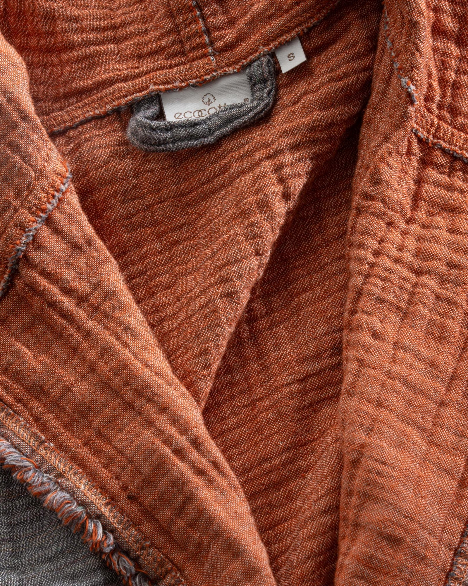 Close-up of the Women's Muna Organic Aegean Cotton Gauze Two-Sided Robe in Terra n Slate colour, highlighting the soft texture, elegant design, and visible Ecocotton tag