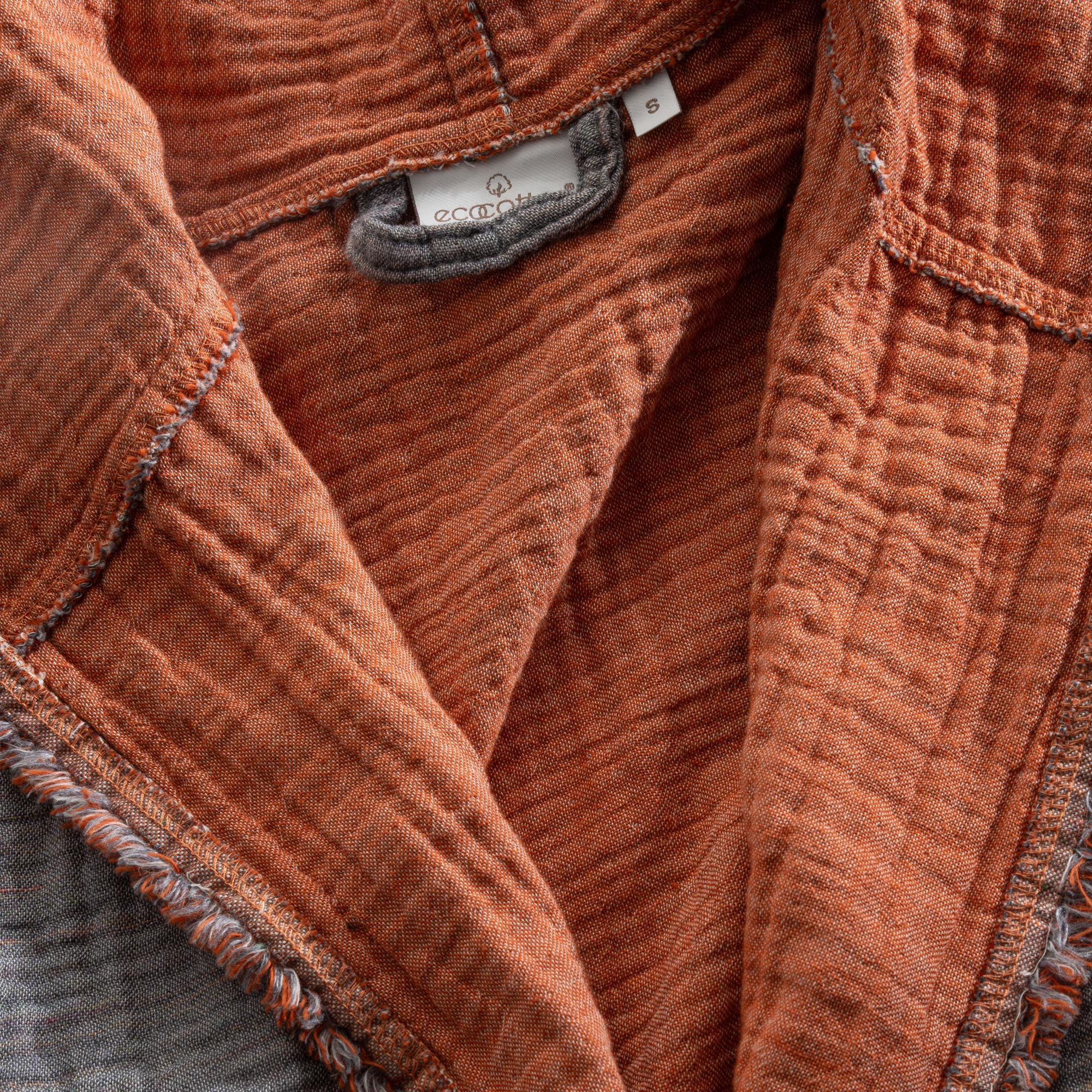 Close-up of the Women's Muna Organic Aegean Cotton Gauze Two-Sided Robe in Terra n Slate colour, highlighting the soft texture, elegant design, and visible Ecocotton tag