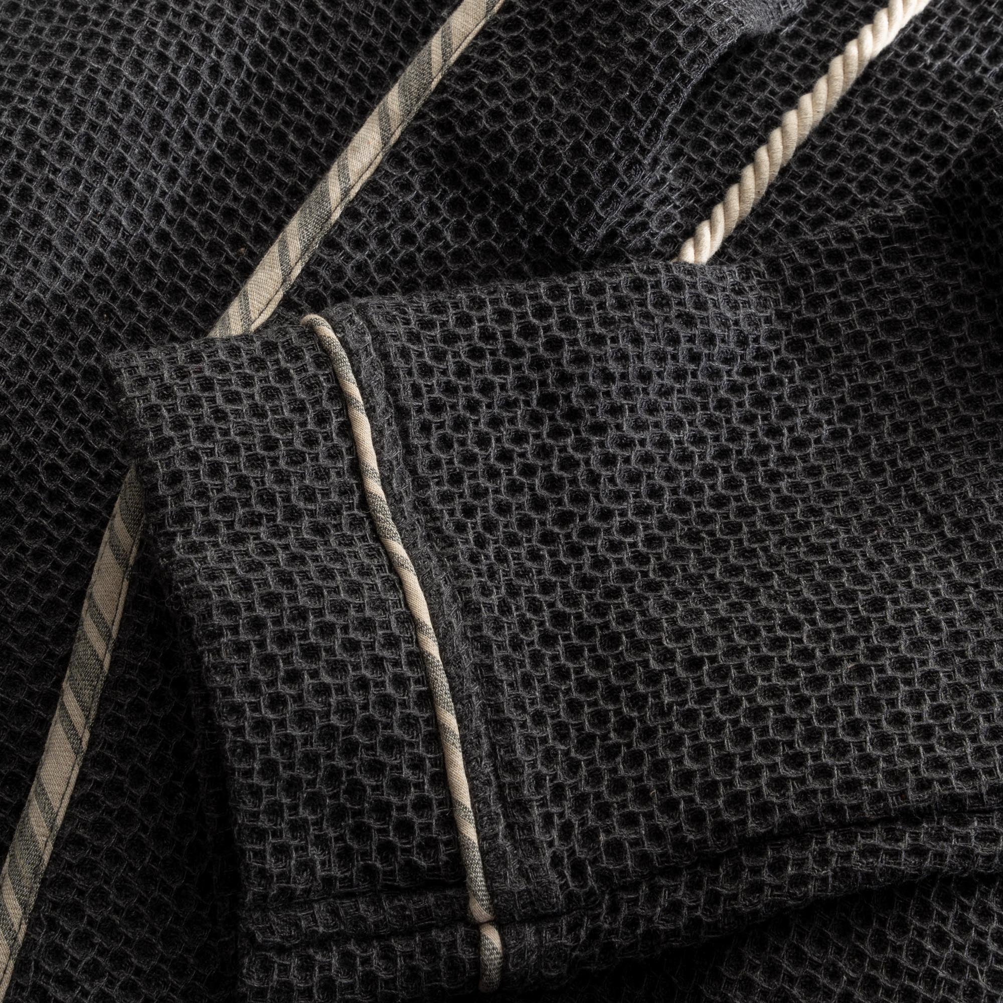 A close up shot of Minoa's Naia Panama Weave Mens Robe showing its robe sleeve with fine texture