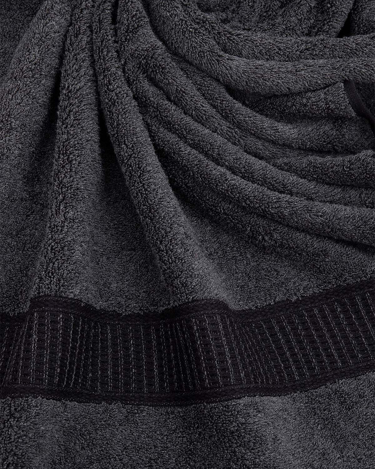 Close-up of a dark gray towel with textured border