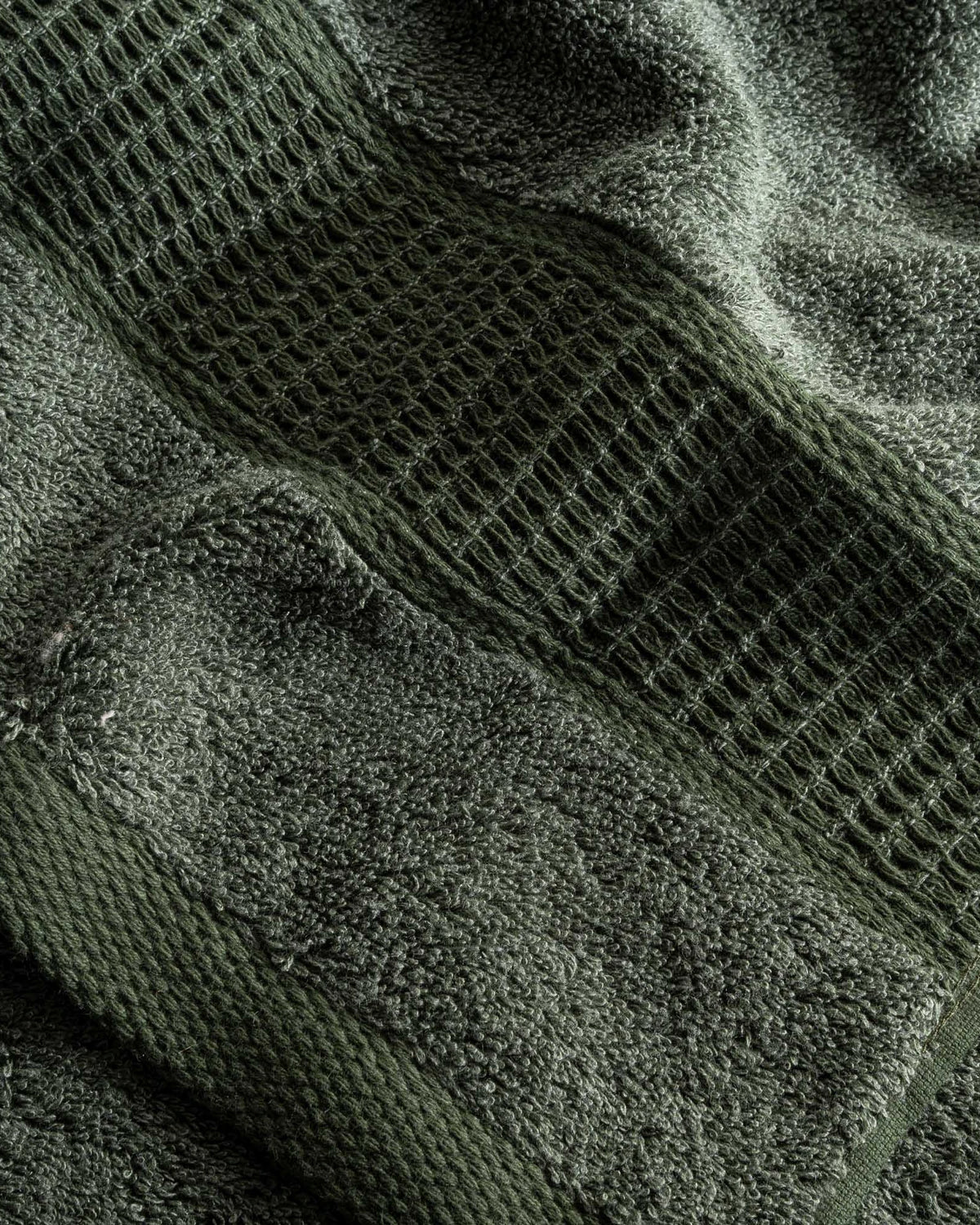 Close-up of green textured towel with a patterned design