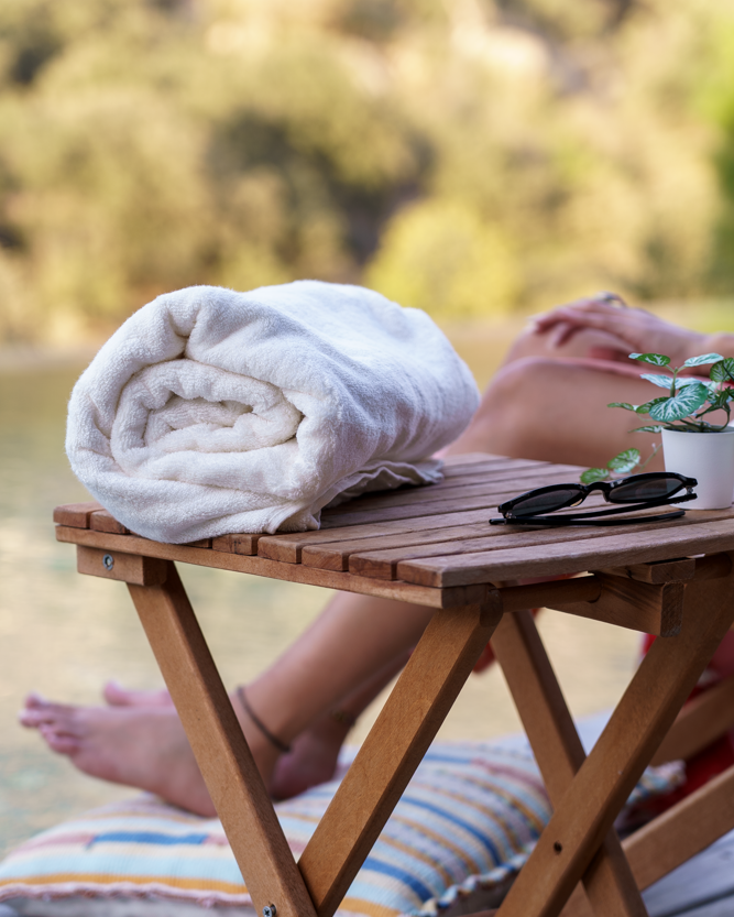 Plush Lite 500-gram Aegean Cotton guest bath towel pack of four in Moonlight Pearl by Minoa USA Canada, rolled up to showcase soft texture, elegant color, and premium organic bath towels quality