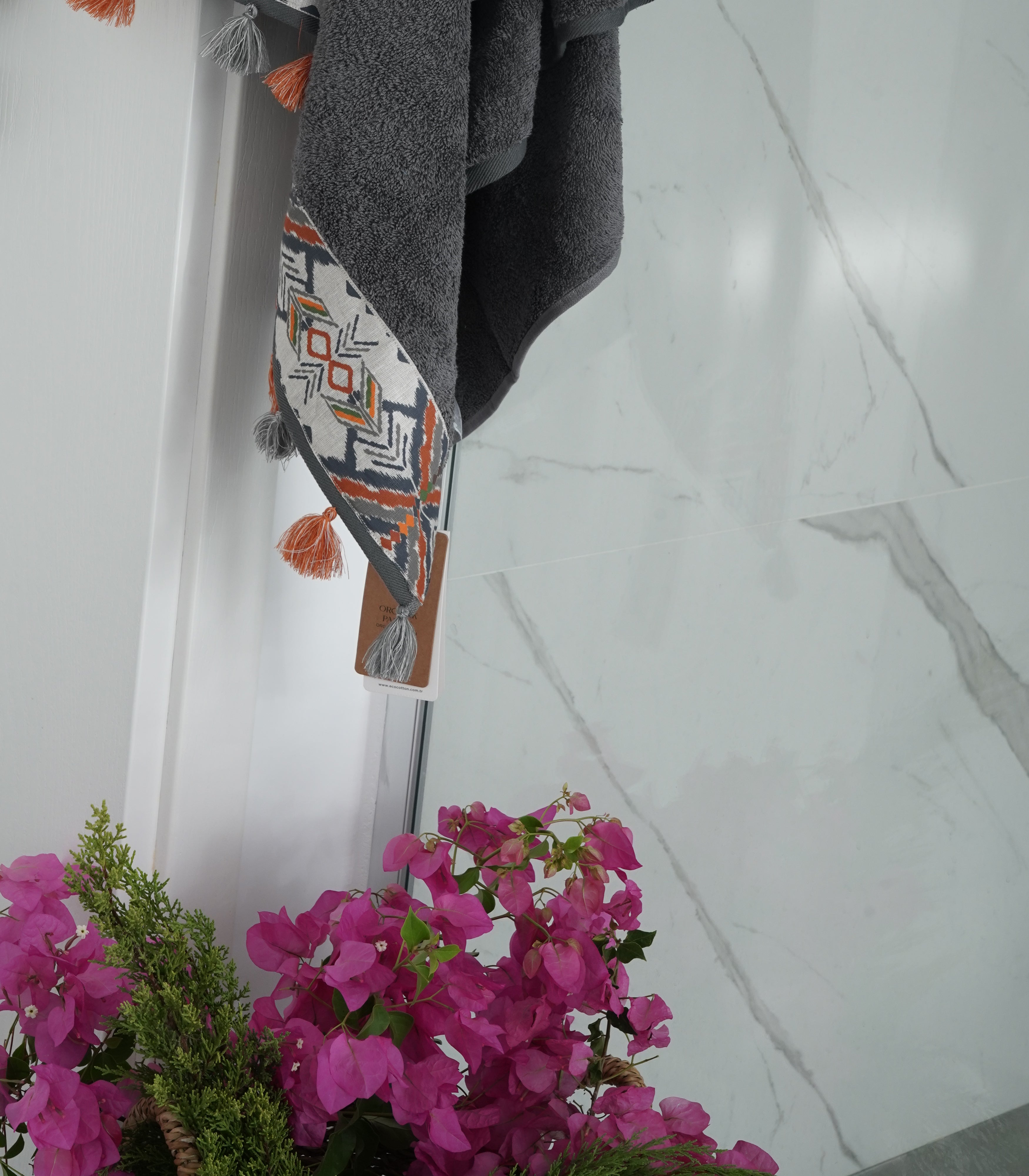 Pamira Organic Aegean Cotton organic Bath Towel in Dark Pearl, hanging neatly, showcasing its soft texture, rich colour, and luxurious fabric