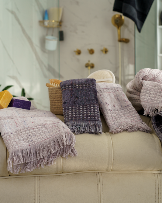 Minoa Maia organic cotton and viscose bath set placed on a couch, showcasing sustainable luxury and the softness of organic bath towels in USA and Canada