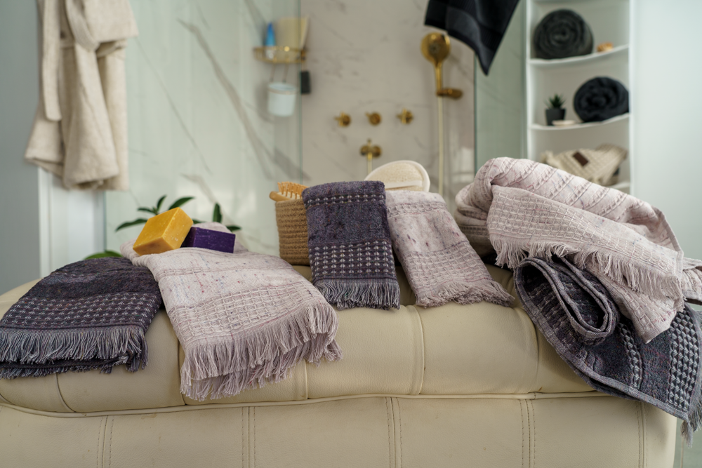 Minoa Maia organic cotton and viscose bath set placed on a couch, showcasing sustainable luxury and the softness of organic bath towels in USA and Canada