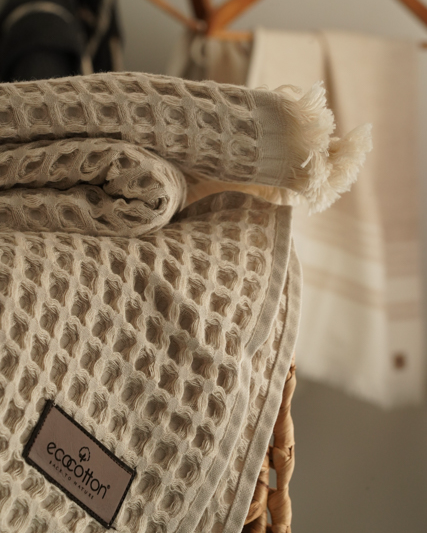 Close-up of Minoa USA Canada Seren organic cotton waffle luxury bath towels with flowers, showing their plush texture, elegance, and sustainable luxury