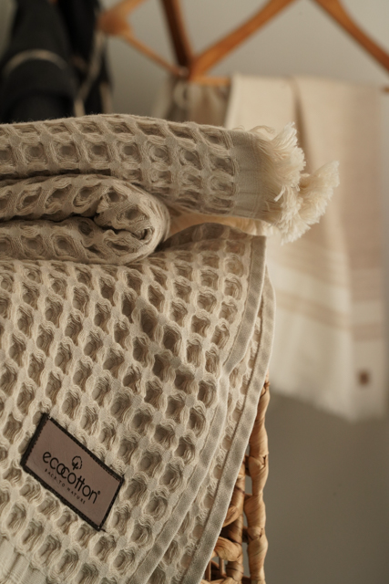 Close-up of Minoa USA Canada Seren organic cotton waffle luxury bath towels with flowers, showing their plush texture, elegance, and sustainable luxury