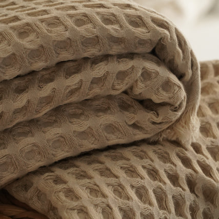 Close-up of beige Organic Aegean Seren Waffle Large Throw/Bed Spread 400-gram, showcasing its soft waffle texture and eco-friendly organic cotton construction