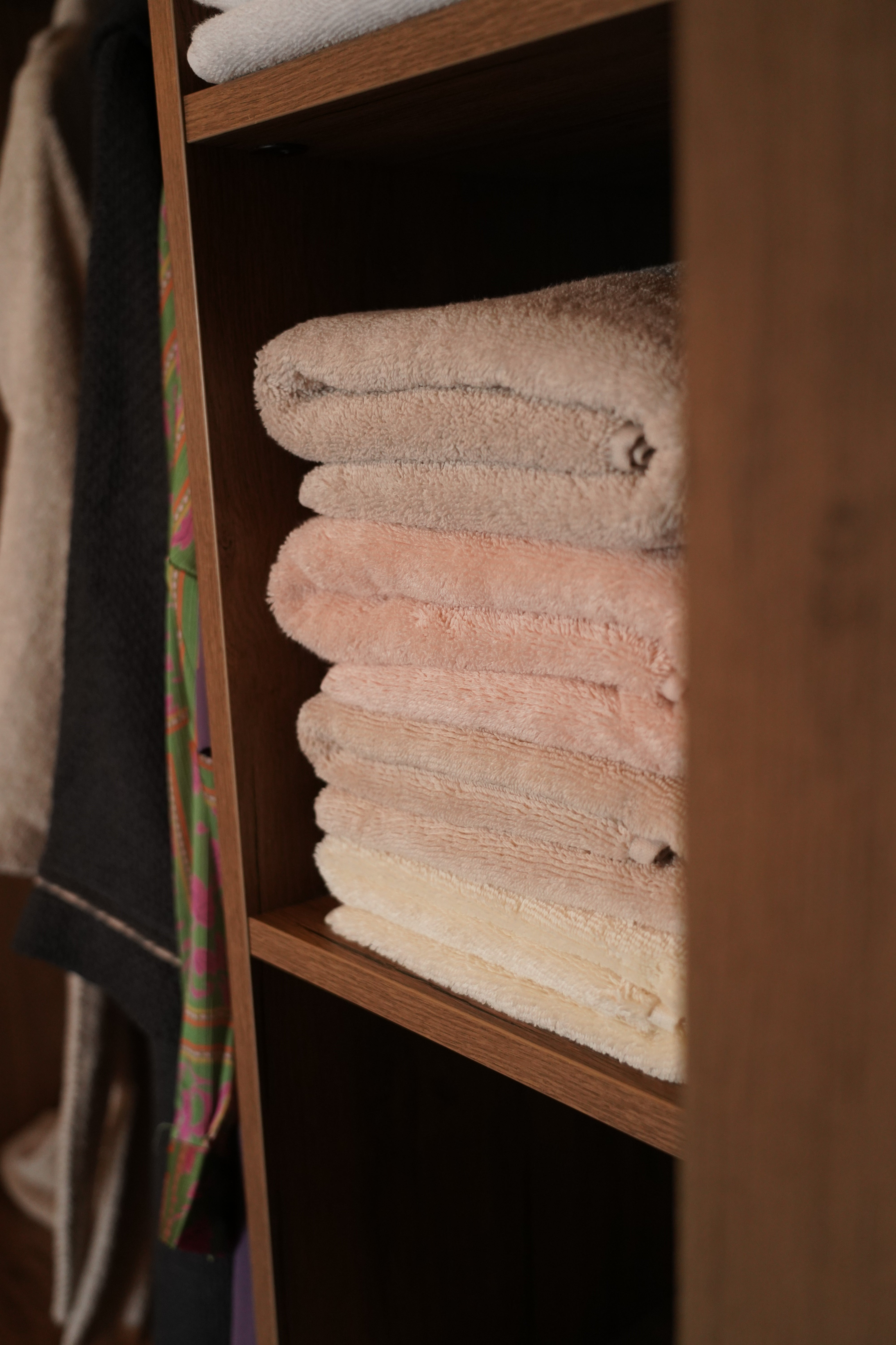 Monte Rosa 820-Gram Aegean Cotton XL Sheet Set neatly stacked on a wooden shelf, highlighting its plush texture and natural elegance