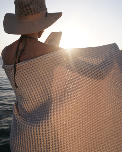 Woman wrapped in Yummy Vanilla Seren organic cotton waffle luxury bath towel