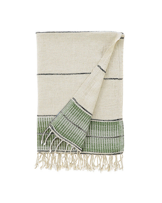 Beige and green towel with fringes on a white background
