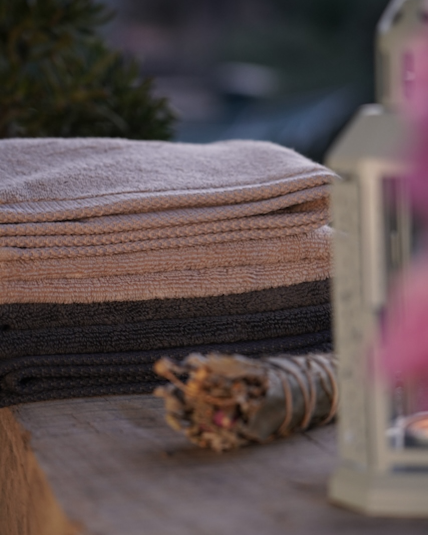 Stack of folded towels on a surface with a blurred background