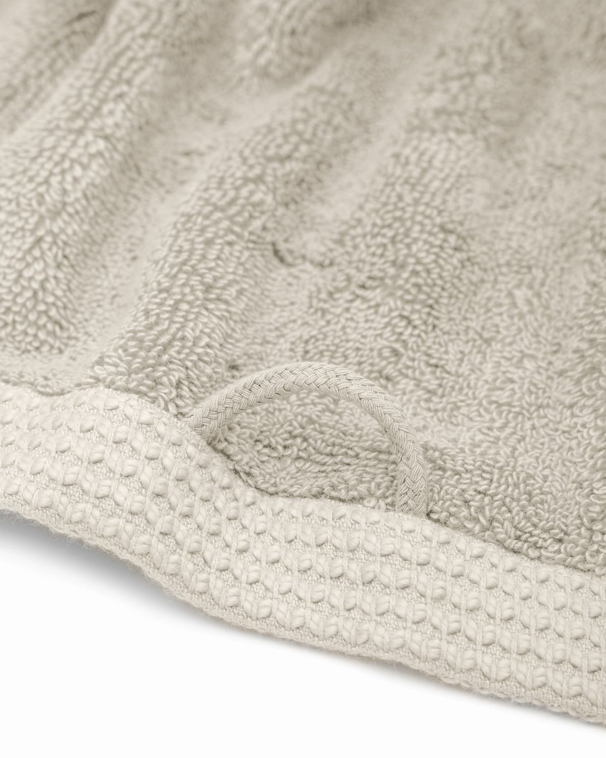 Jasper 600-gram organic Aegean cotton luxury bath, hand, and washcloth towels in Vanilla Embrace with hanging loop for easy storage, showcasing soft plush texture, warm color, and luxurious fabric