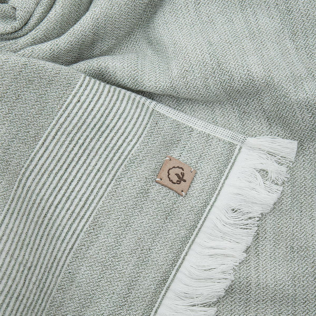 Close-up of the three-piece Hasna Organic Aegean Cotton and Linen Bath Set in Pine Breeze, highlighting the rich color, soft texture, and detailed craftsmanship