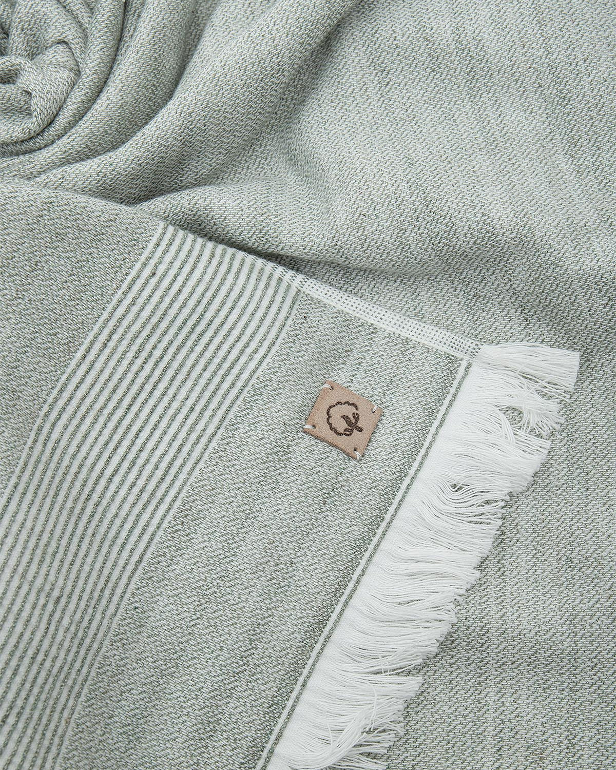 Close-up of the three-piece Hasna Organic Aegean Cotton and Linen Bath Set in Pine Breeze, highlighting the rich color, soft texture, and detailed craftsmanship