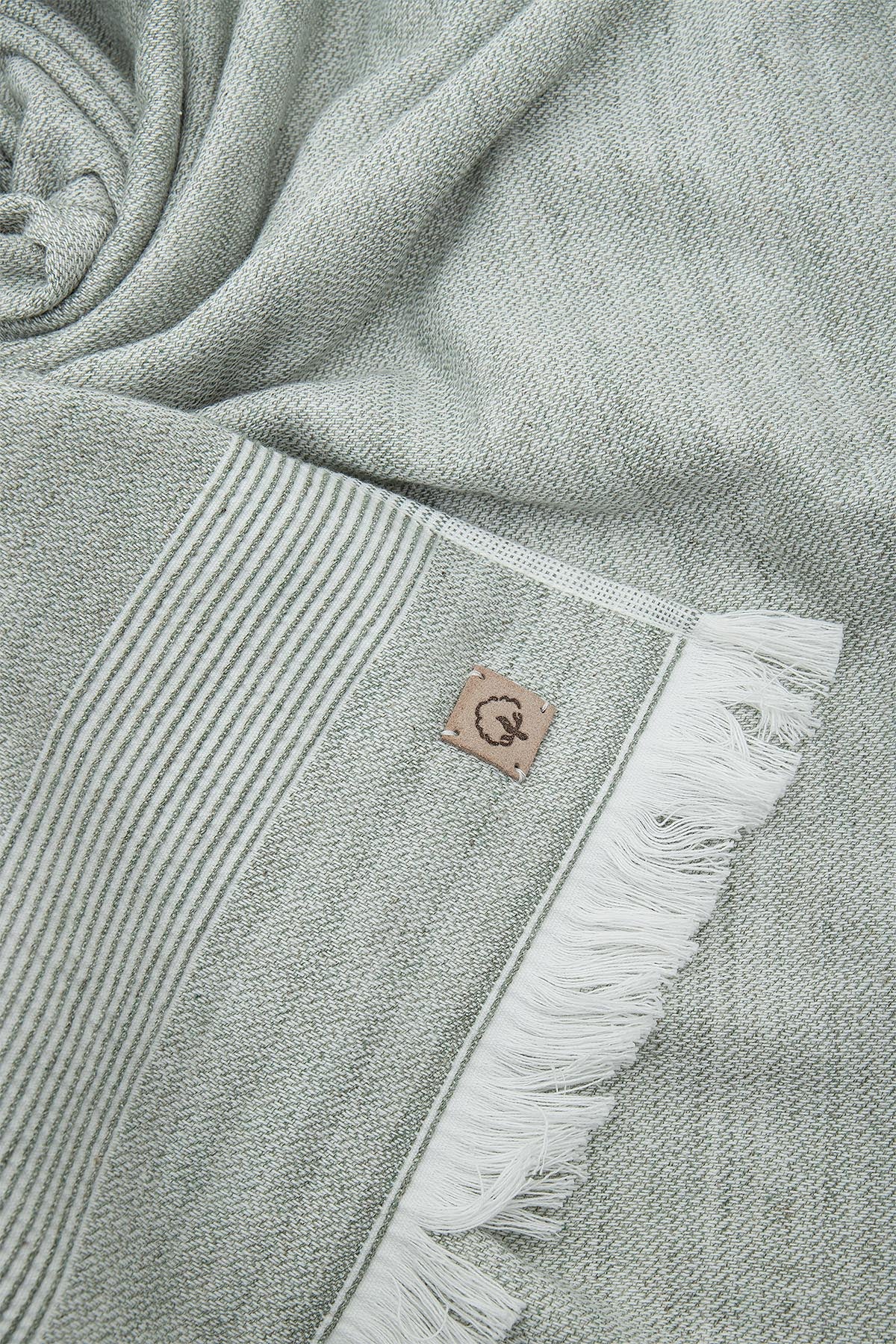 Close-up of the three-piece Hasna Organic Aegean Cotton and Linen Bath Set in Pine Breeze, highlighting the rich color, soft texture, and detailed craftsmanship