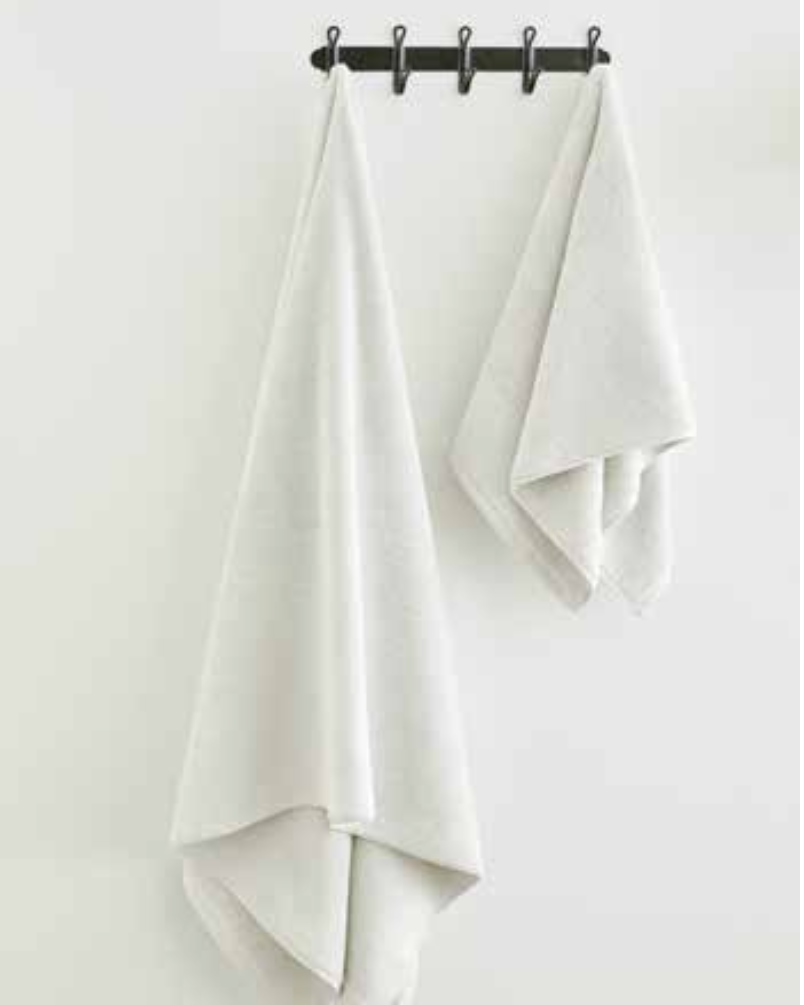 Two Sardes 550-GSM Organic Cotton Towel in white hanging, an organic cotton towel made from 100% GOTS Certified Organic Cotton.