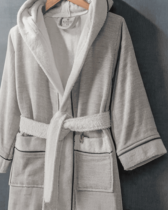 Soft grey HASNA bathrobe featuring a plush, cozy fabric with a belted waist and relaxed fit, perfect for lounging and after-bath comfort