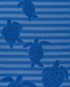 Royal blue Jenka beach towel with sea turtle motifs on striped background by Minoa Home.