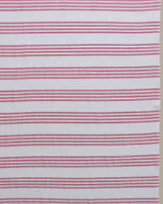 Fuchsia/White Nesta beach towel made with 100% organic cotton, with a luxuriously soft texture and carefully fabricated comfort