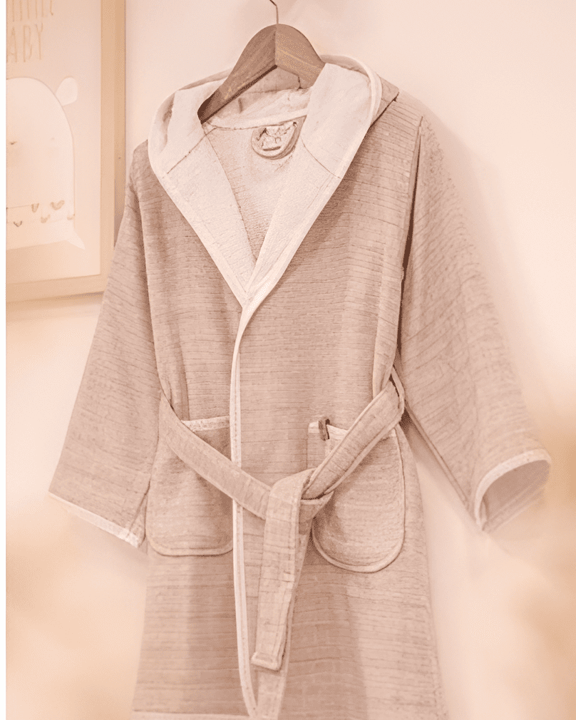 Elegant pink HASNA bathrobe made from luxurious, soft fabric, with a gentle hue and a comfortable belted design for a relaxing experience