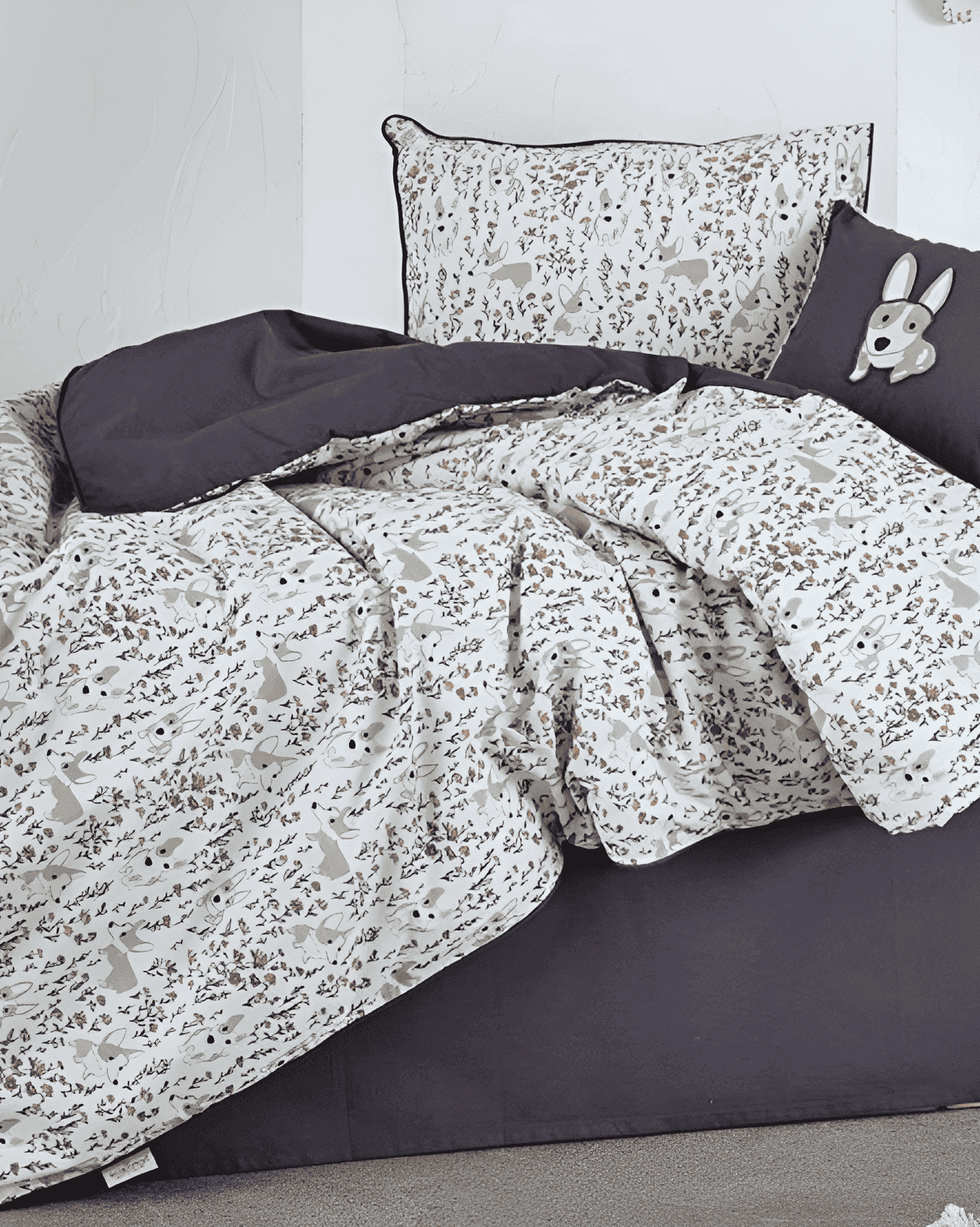 Bedding set with gray and white pattern on a bed