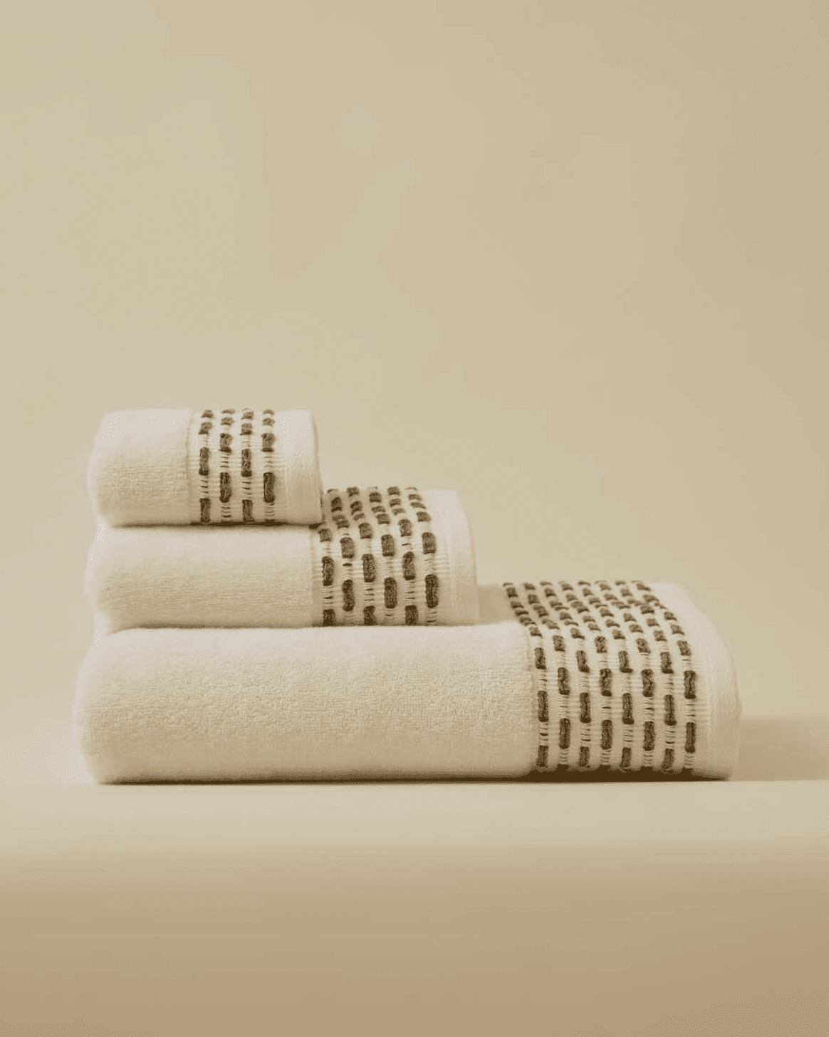 Calm 550-GSM Cotton Towel in ivory and green, an organic cotton towel providing a plush, absorbent texture with a fresh and soothing color combination.