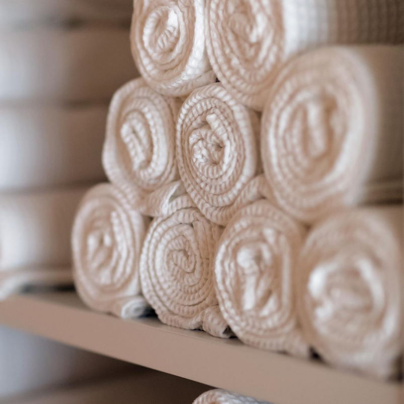 A stack of white towels on the shelf