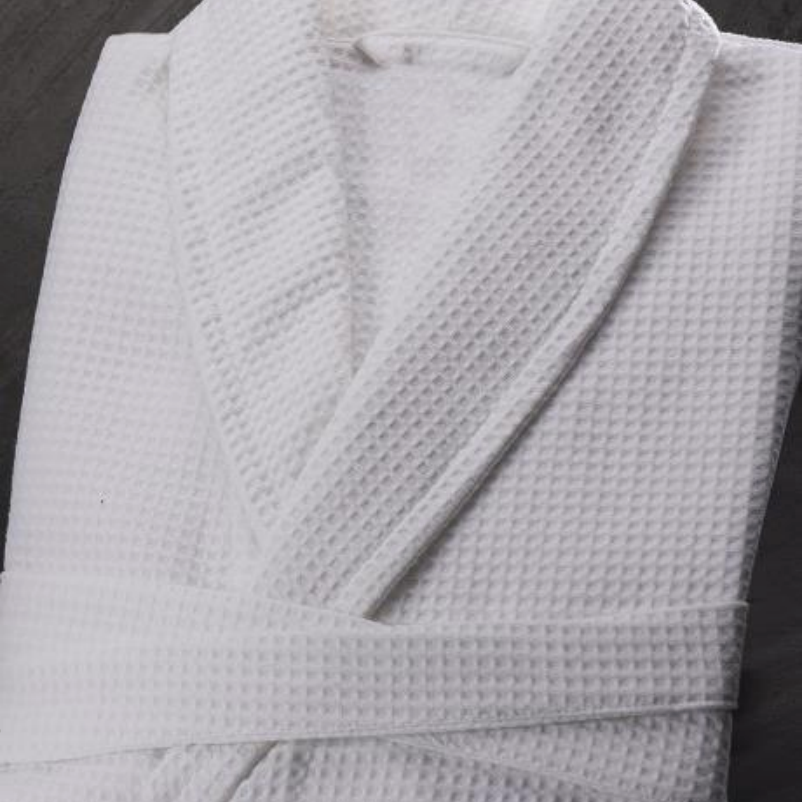A folded white robe with matching belt
