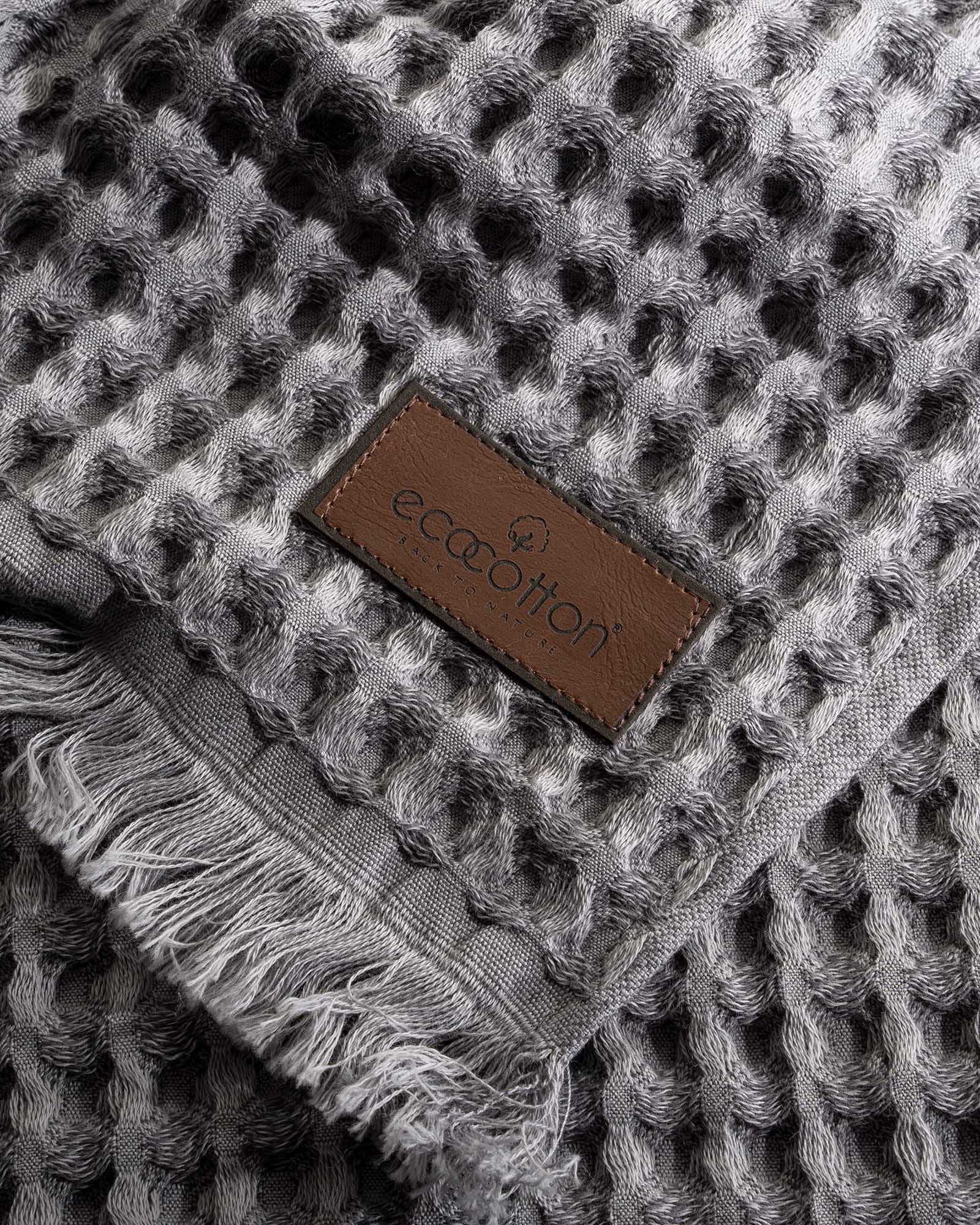 Close-up of Ecocotton tag on Silver Delight Seren organic cotton waffle luxury bath towel, highlighting its sustainable and eco-friendly certification