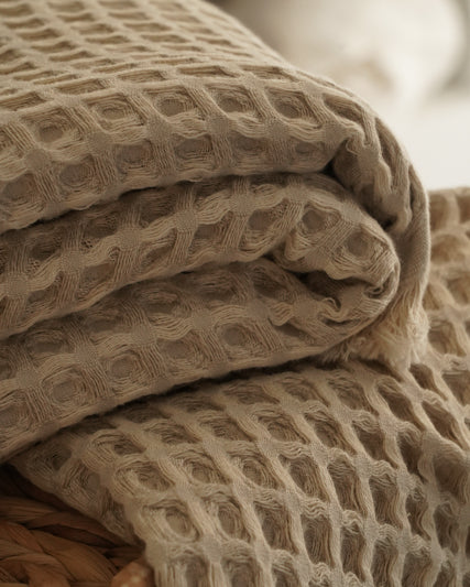 Close-up of beige Organic Aegean Seren Waffle Large Throw/Bed Spread 400-gram, showcasing its soft waffle texture and eco-friendly organic cotton construction