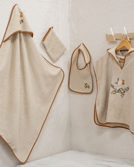 Beige baby Poncho set with embroidered designs on a white background