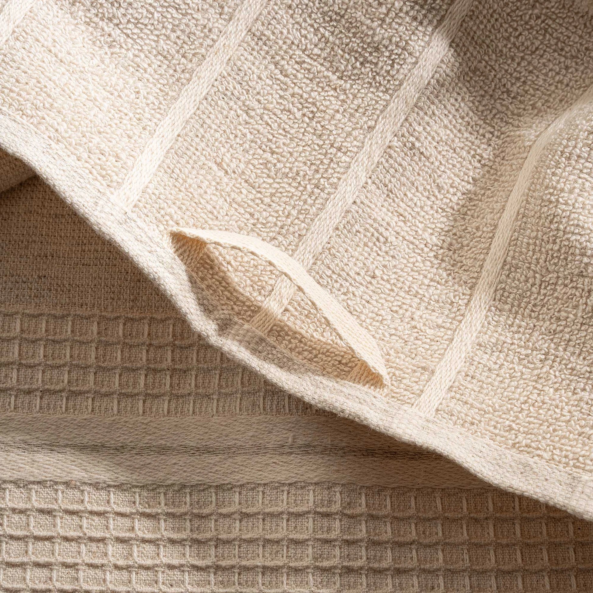 Arden Hemp and Organic Cotton Bath Towel with tassels in sand and white showcasing its soft texture natural color and delicate tassel details as a luxury bath towel and organic bath towel