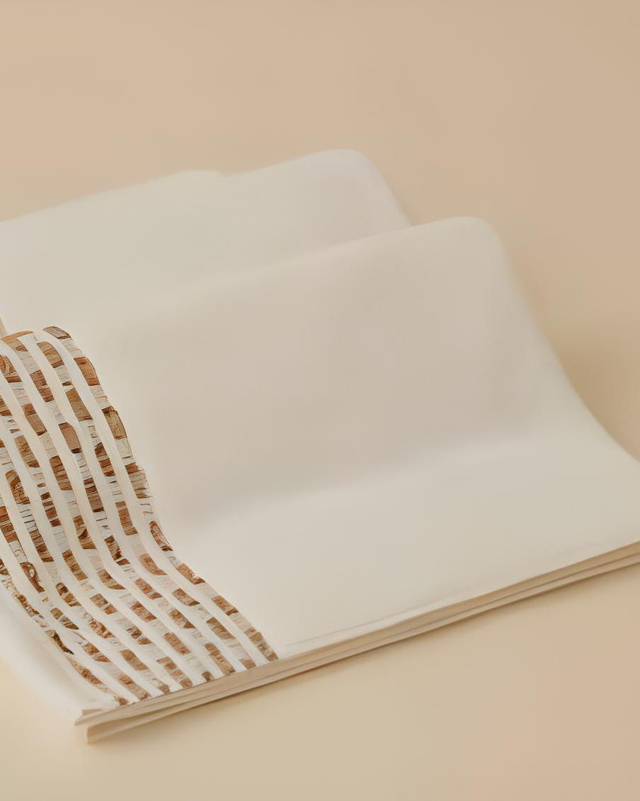 Calm 550-GSM Cotton Towel in ivory and beige, an organic cotton towel offering a soft, plush feel with elegant color contrast for a sophisticated look.