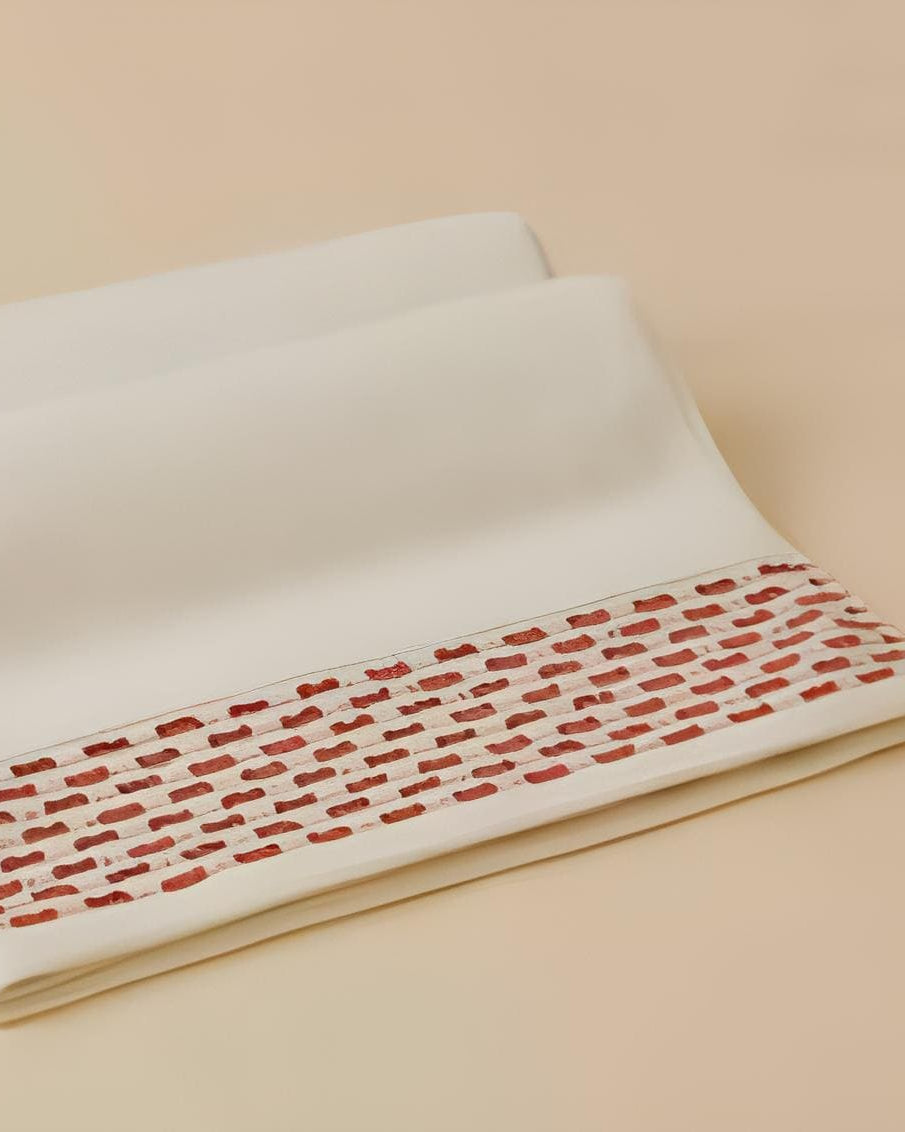 Calm 550-GSM Cotton Towel in ivory and brick, an organic cotton towel featuring a soft cotton feel and a warm, inviting color contrast.