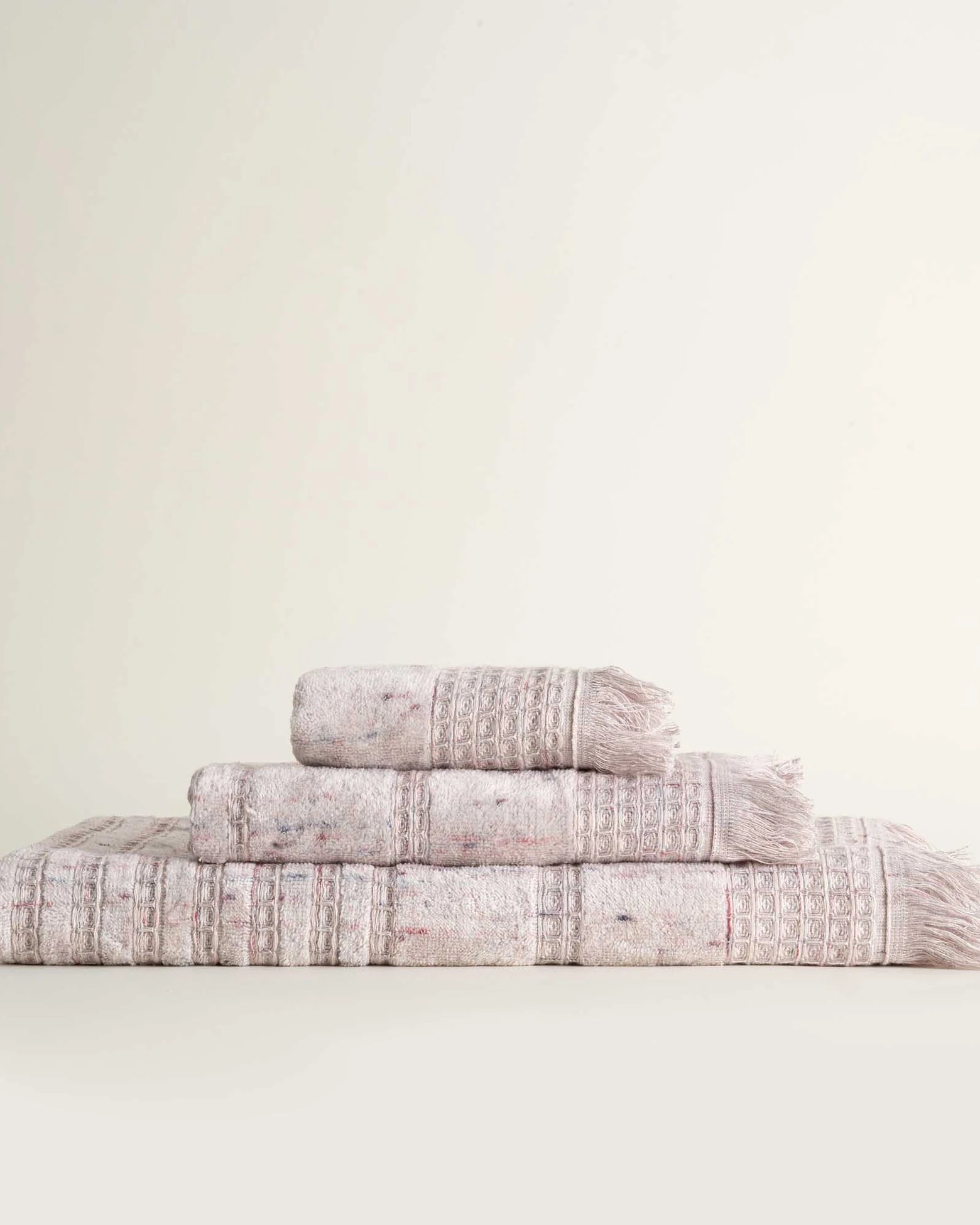 Front view of Maia organic cotton bath hand and washcloth set in Pink Powder neatly arranged to highlight its soft texture and eco friendly design of organic bath towels