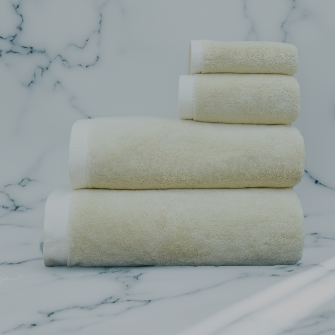 Raw Elegance Monte Rosa 820-gram organic Aegean cotton luxury bath towel set with four neatly arranged towels, reflecting natural elegance and luxurious plush softness