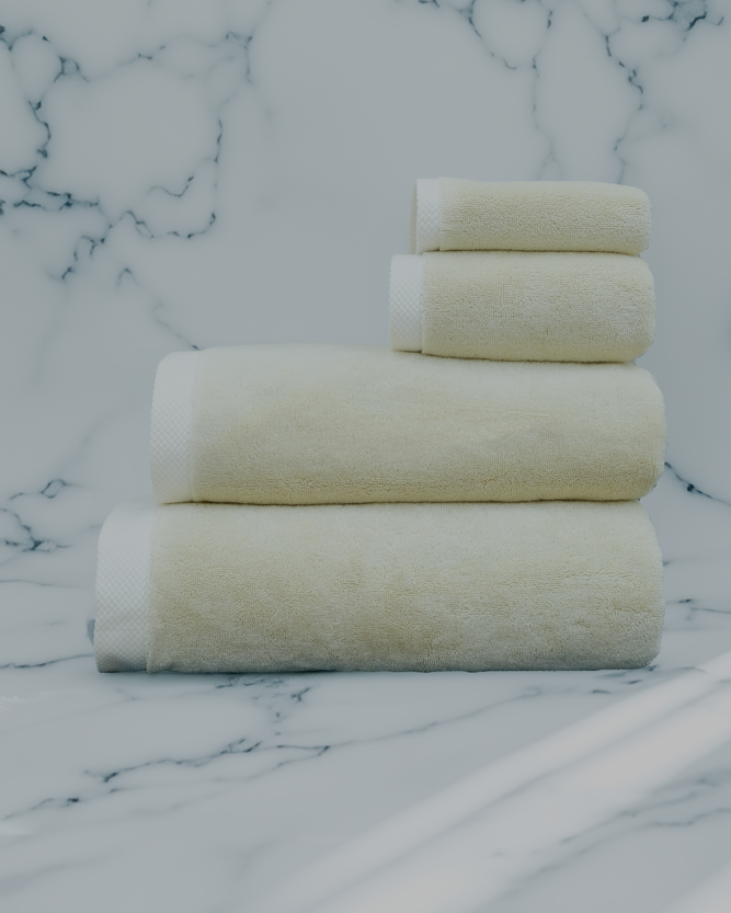 Raw Elegance Monte Rosa 820-gram organic Aegean cotton luxury bath towel set with four neatly arranged towels, reflecting natural elegance and luxurious plush softness