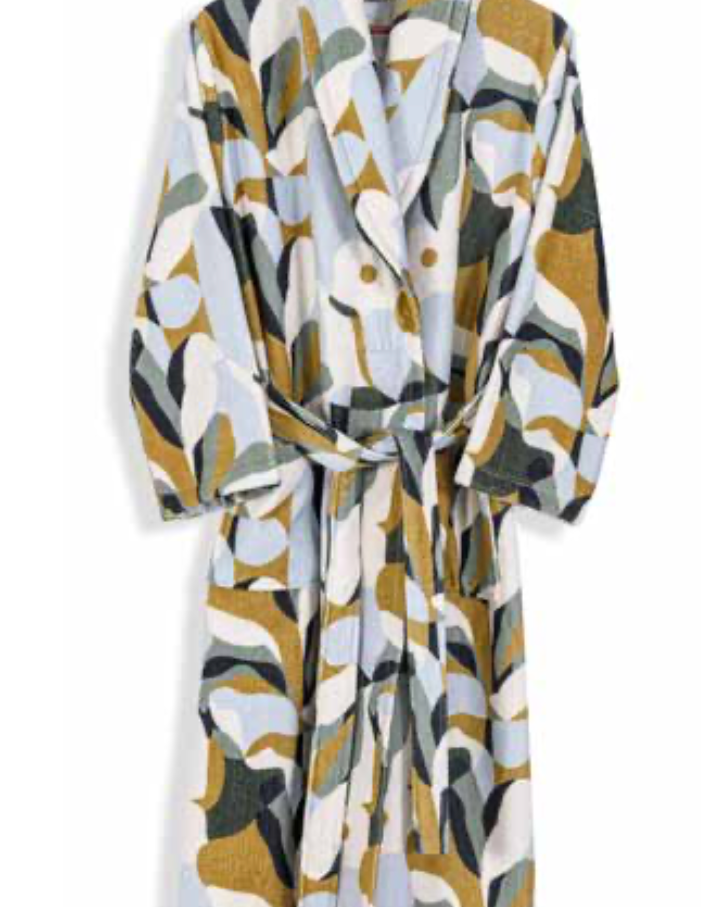 White bathrobe with abstract earth-toned pattern in olive, mustard, and soft blue — bold modern sustainable textile design.