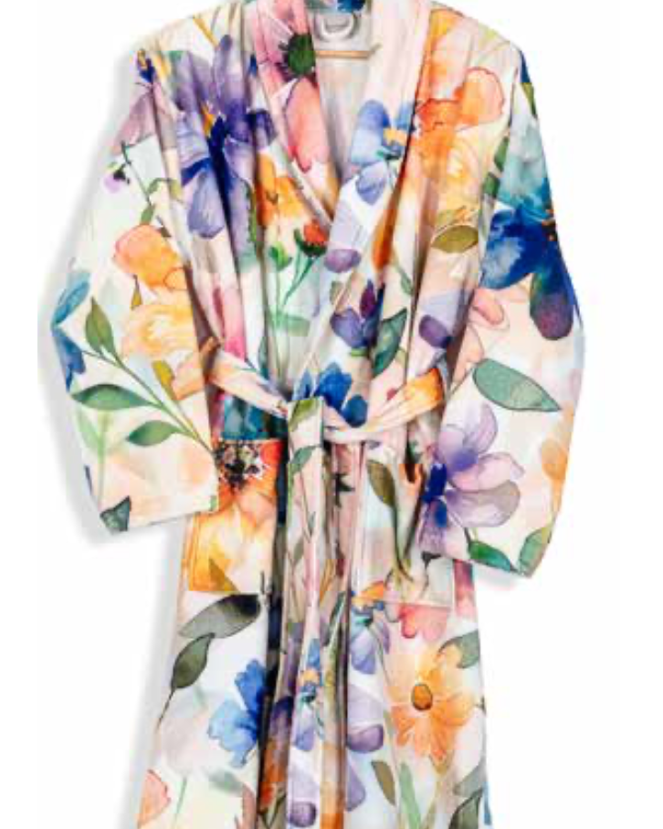 Colorful floral print bathrobe with belt tie on hanger — bold and artistic eco-luxury home textile design.