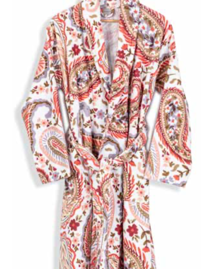 White bathrobe with vibrant red and brown paisley print hanging on wooden hanger — artistic sustainable textile for eco-conscious homewear.