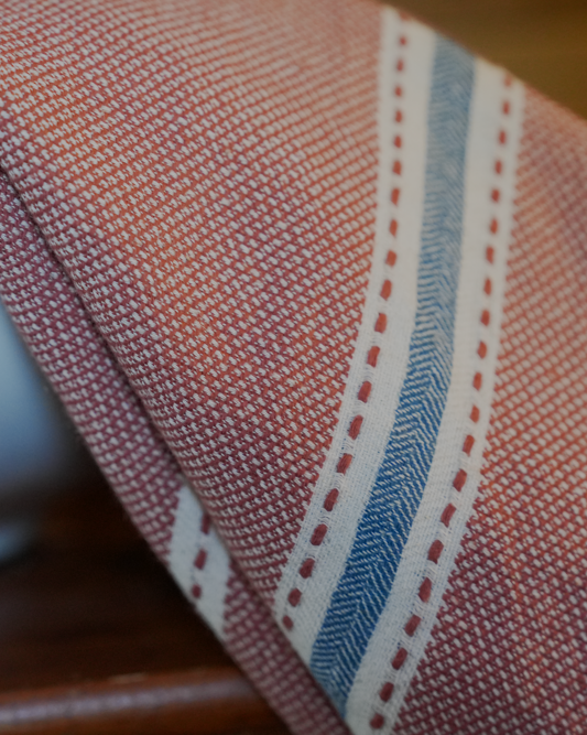 Close-up view of hazelnut colored Tulum 200 gram Aegean Cotton and Linen Turkish towel showing fine handwoven cotton texture and blue white stripes by Minoa Home highlighting the softness and quality of an organic bath towel