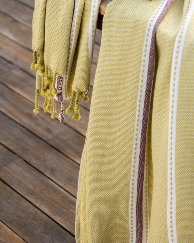 Handwoven olive green Tulum 200 gram Aegean Cotton and Linen peshtemal towel by Minoa Home featuring eco friendly cotton with white and maroon stripes, showcasing the softness and quality of an organic bath towel