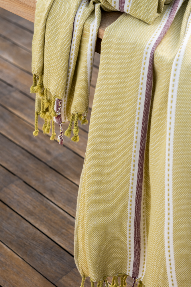 Handwoven olive green Tulum 200 gram Aegean Cotton and Linen peshtemal towel by Minoa Home featuring eco friendly cotton with white and maroon stripes, showcasing the softness and quality of an organic bath towel