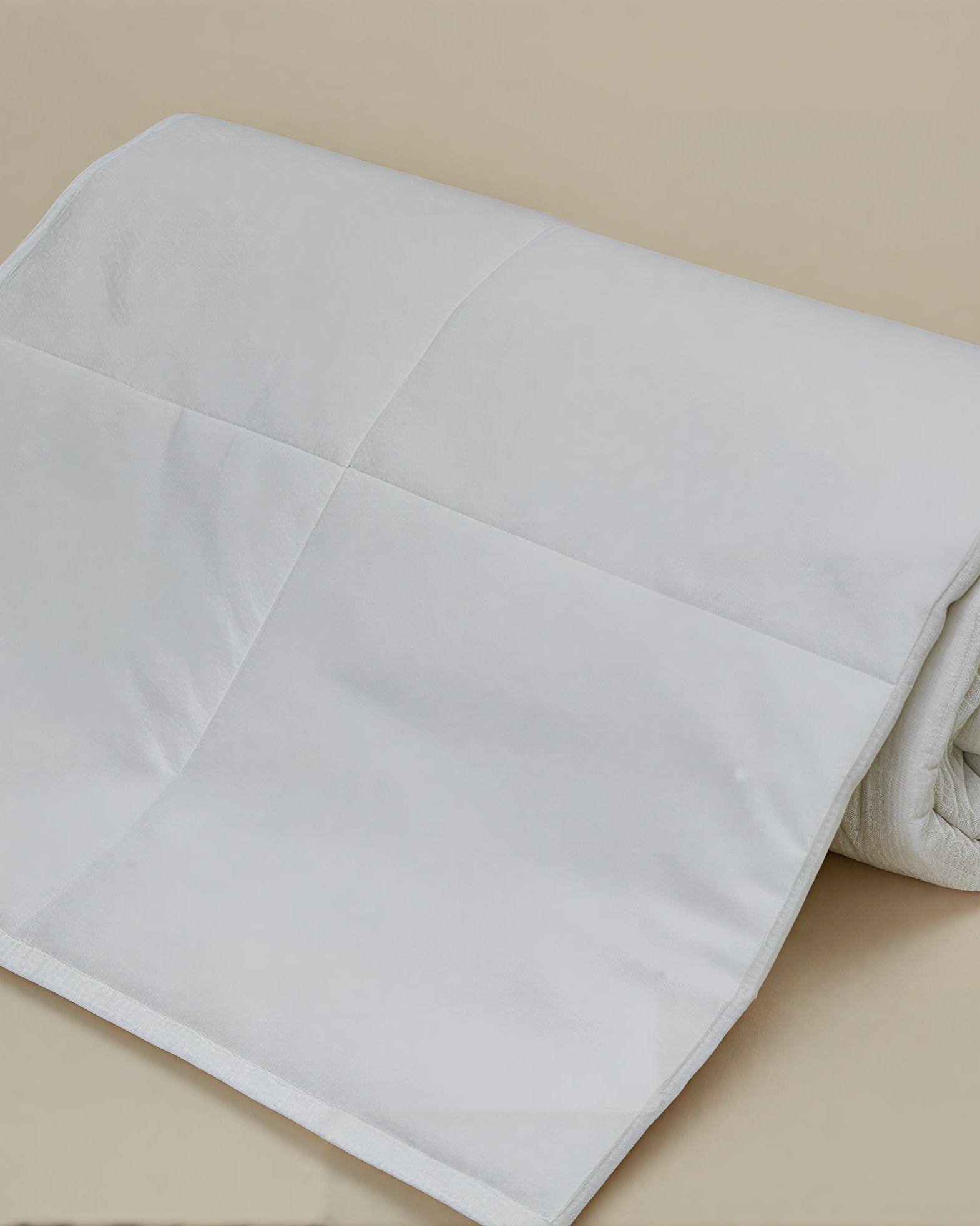 Rolled organic cotton duvet insert by Minoa Home, made with organic sheets, breathable and lightweight for all-season comfort.