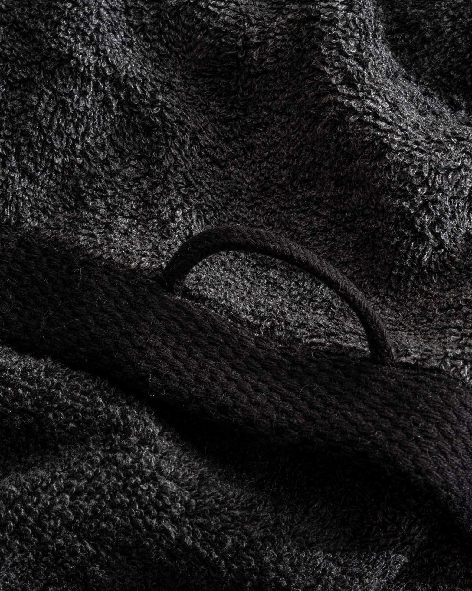 Naia & Cotton Luxury Hand Towel in Dark Pearl, folded with a round loop for hanging, showcasing its soft texture, rich colour, and luxurious fabric