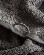 Close-up of the Pamira Organic Aegean Cotton Bath & Hand Towel Duo in Dark Pearl, showcasing its soft texture, rich colour, and luxurious fabric, with a round loop for hanging