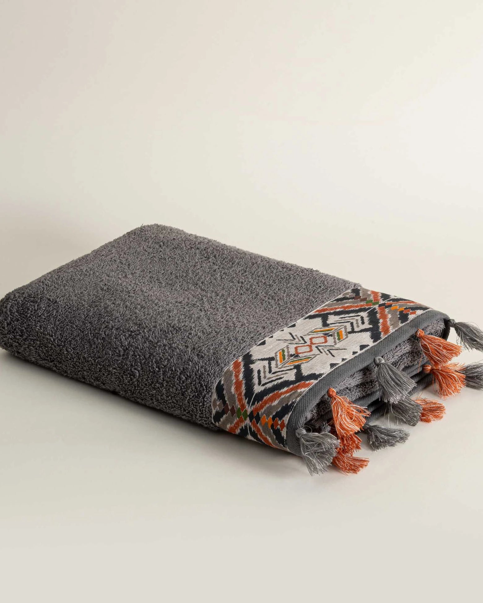 One folded Pamira Organic Aegean Cotton Bath & Hand Towel Duo in Dark Pearl, showcasing its soft texture, rich colour, and luxurious fabric