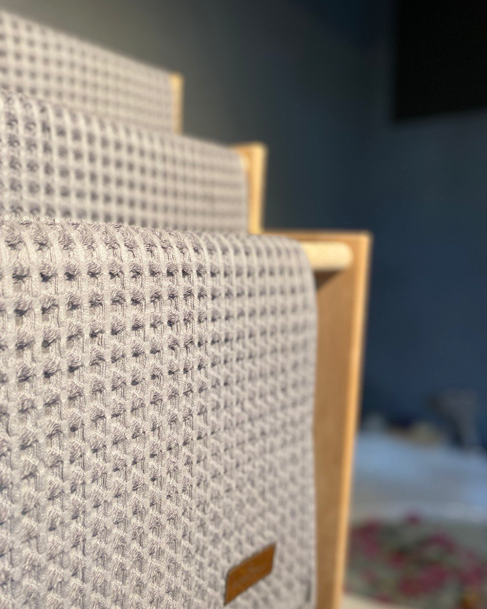 Minoa USA Canada Seren organic cotton waffle luxury bath towels hanging with plush waffle texture, showcasing sustainable luxury