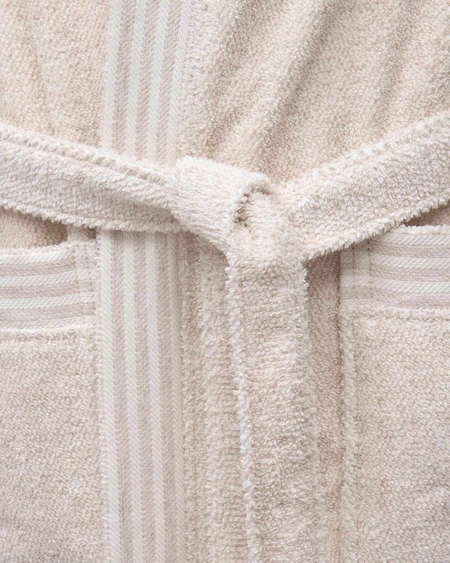 Minoa's Raisa Hemp & Organic Cotton Mens Robe, a sustainable luxury bath robe featuring a delicately designed self-tied belt for comfort and elegance.